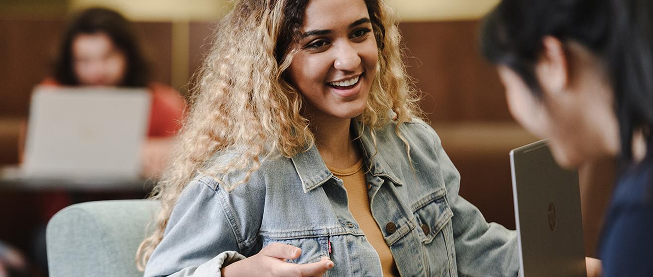 Student smiling in class at the University of Akron